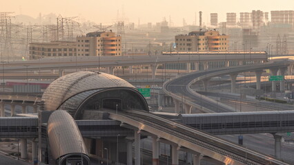 Futuristic building of Dubai metro station and luxury skyscrapers behind in Dubai Marina aerial timelapse, United Arab Emirates