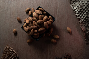 close up some almonds in bowl in dark background