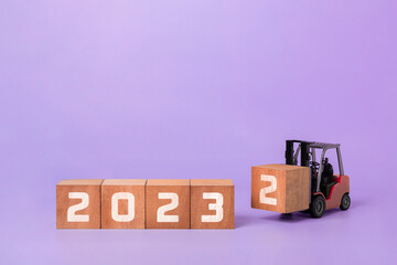 Happy new year 2023 industrial concept. new year background design concept,  forklift carrying box...