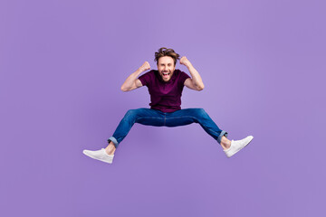 Full size photo of young man jump up fists hands luck lottery triumph isolated over violet color background