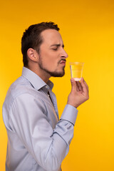 The guy in the shirt holds a plastic cup with water