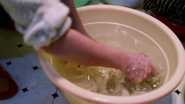 A woman who washes clothes by hand