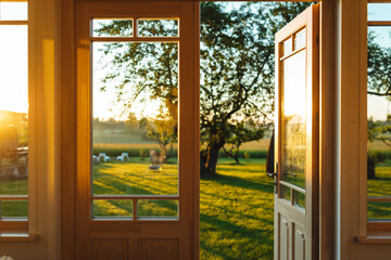View on garden from house during epic sunrise, countryside home garden