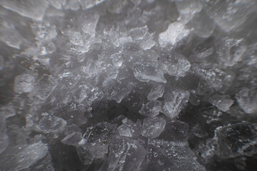 Close-up of crystals of dark sea iodized salt. Extreme macro background minerals salt