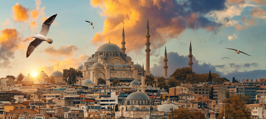 Fototapeta premium Beautiful view of gorgeous historical Suleymaniye Mosque, Rustem Pasa Mosque and buildings in front of dramatic sunset. Istanbul most popular tourism destination of Turkey. Travel Turkey concept.
