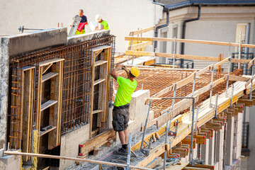 Builders working on roof of house. 