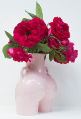 red roses in a vase on a white background