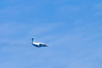 Airplane in blue sky. Air cargo transportation. Plane is flying