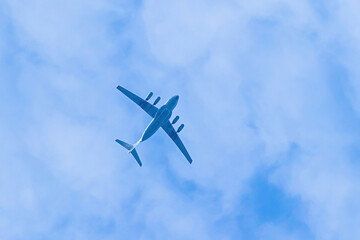 Airplane is flying in blue sky. Commercial passenger and cargo a