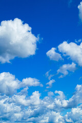 Naklejka na ściany i meble Beautiful summer blue sky. Fluffy white cumulus clouds.