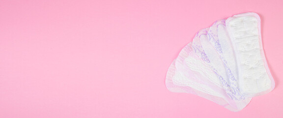 Set of sanitary pads on pink background. Daily feminine hygiene product.