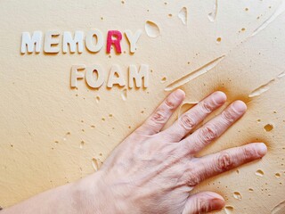 hand sinks onto a soft memory foam pillow