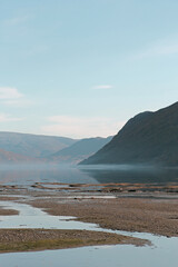 Low tide in the Norwegian fjords. Vertical photo.
Foggy day.