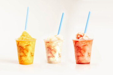 Frozen slushes mango peach strawberry guava and lemon flavour in plastic cups with straws.