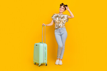 Photo of sweet pretty woman wear print t-shirt arms dark spectacles carrying baggage isolated yellow color background