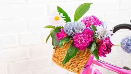 Bicycle basket with a bouquet of flowers
