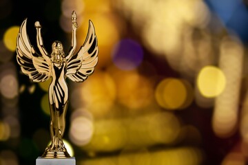 Golden award statue on fireworks background. Success and victory concept.