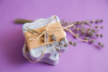 Handmade natural bath spa lavender soap on violet background. Soap making. Soap bars. Spa, skin care. Gift wrapping.