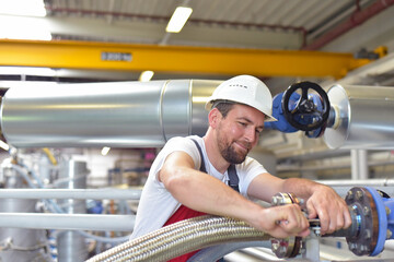 Mechanics repair a machine in a modern industrial plant - profession and teamwork