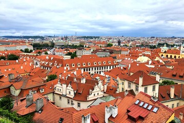 Fototapeta na wymiar Prague, Czech Republic. Mala Strana, Lesser Town of Prague. Top view , downtown, panorama. Ancient old buildings with red tiled roofs, church, tower, castle