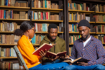 happy young university students studying with books in library.