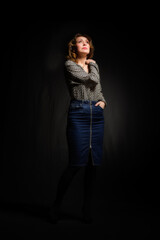 Low key fashion portrait of elegant woman over black background