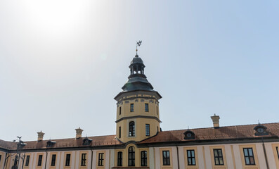 Fototapeta na wymiar Spire of the castle tower of Nesvizh Castle, Belarus. Medieval castle and palace. Heritage concepts.