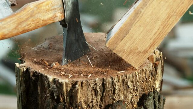 Super slow motion of chopping wooden logs with axe. Filmed on high speed cinema camera, 1000 fps.