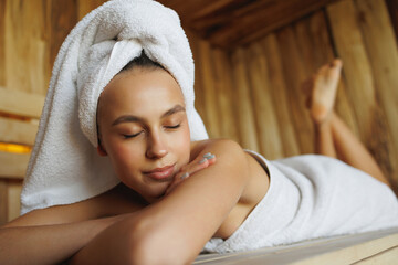Woman with closed eyes enjoying the sauna