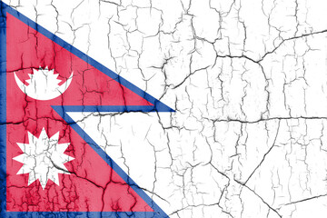 Textured photo of the flag of Nepal with cracks.