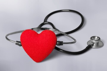 Red heart with medical stethoscope, heart health, health insurance concept, World heart day.