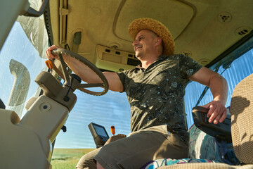 Farmer with tractor in canola field © Xalanx
