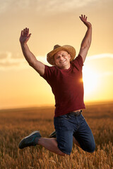 Farmer jumping for joy in the wheat field