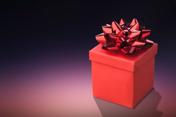 Red gift box on gradient background.