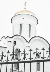 White Orthodox Church. Forged fence close-up. Russia, the city of Krasnodar.