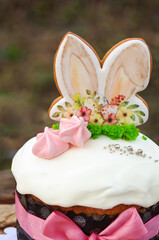 Gingerbread cookies in the shape of bunny ears and air meringue on the kulich. Easter. Easter bunny.