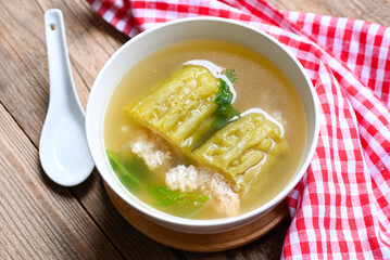 Stuffed bitter gourd with seasoned minced pork soup , Menu healthy food clear soup bowl with bitter gourd or bitter melon soup