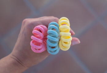 Plastic spiral scrunchies hair band in the hand