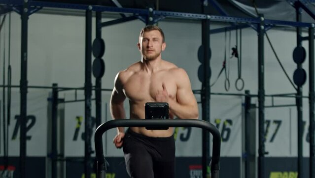 Male athlete athlete is doing cardio training on a treadmill, bodybuilder