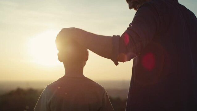 Little boy with dad watching the sunset in summer day. Shot with RED helium camera in 4K.     