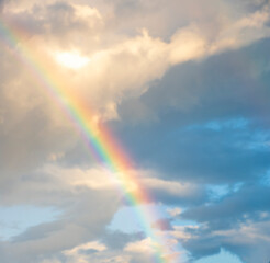 amazing bright rainbow in beautiful evening cloudy sky after rain and thunder, weather concept