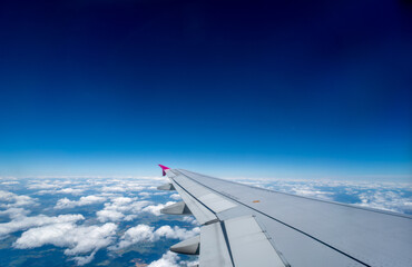 View above the sky with airplane wing