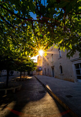 street of Croatian city Trogir with sun star in the tree