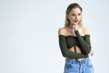 Thoughtful young woman thinking and looking away over white background