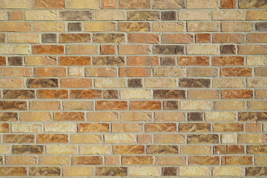 Brown clinker brick wall building. Old style brick wall texture background. Grunge dirty old rusty wall. Yellow and red bricks. Bright wall high resolution texture.