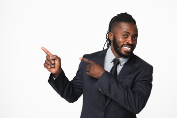 Happy african-american young businessman leader ceo boss bank manager in formal suit pointing at copy space showing free space isolated in white background