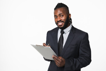 Young confident african-american businessman ceo boss leader manager in formal suit holding clipboard, inspector checking writing data isolated in white background