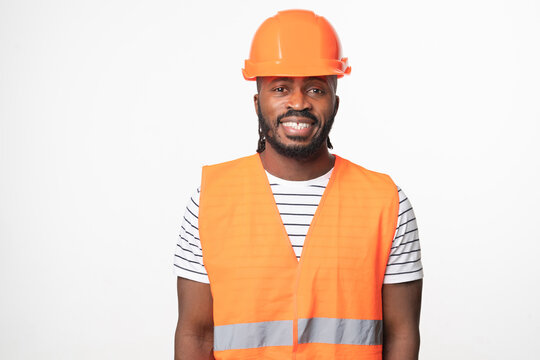 Happy Cheerful African-american Young Man Construction Worker Engineer Architect In Reflective Orange Vest And Hardhat Looking At Camera Smiling Isolated In White Background