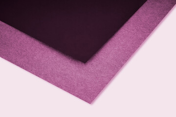 abstract pink background with lines forming triangle looks like side view of an open book plain vs textured cover