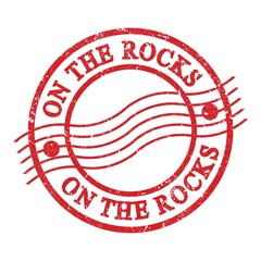 ON THE ROCKS, text written on red postal stamp.